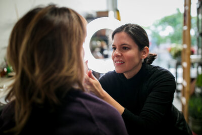 Karyn Carlson applying makeup to a client
