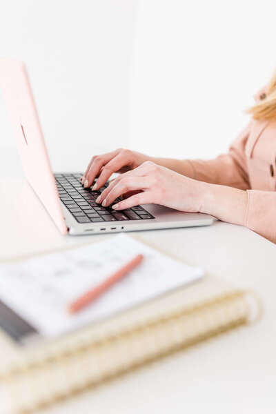 brand and website design for creative entrepreneurs sitting on laptop typing on computers