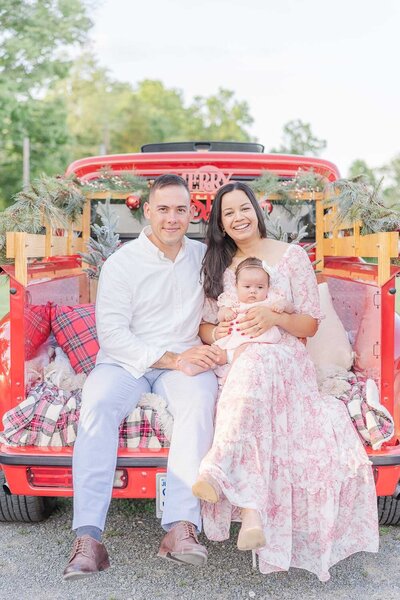 family of 3 during a red truck mini session in Fairfax, Virginia