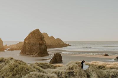 View of an Oregon Coast beach with a couple during their elopement