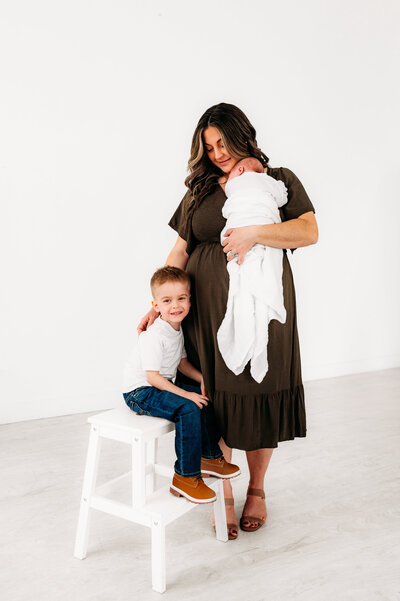 Expecting mother with her young child in a studio setting during Ottawa maternity mini session.