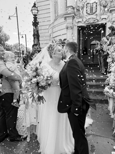 Natural behind the scenes shot of bride and groom sharing a quiet moment