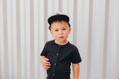 Portrait of young boy with baseball cap smiling at camera