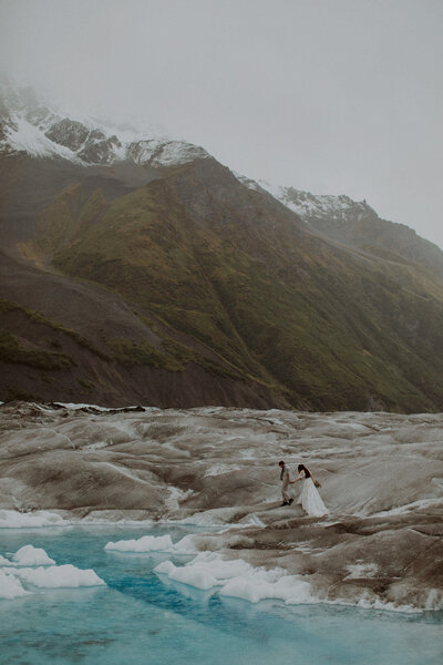 Couple walking on glacier