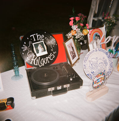 Close up of wedding invitation and other meaningful parts of the wedding, laid out on a table