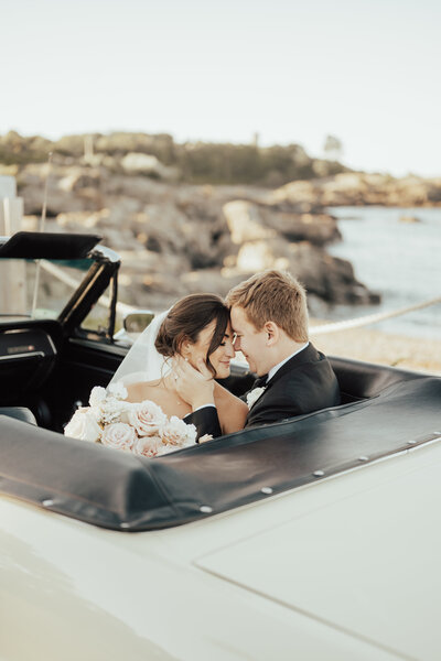 bride and groom sitting in car