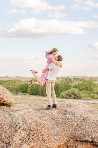 Couple playfully posing together during their engagement session at Vedauwoo near Laramie, Wyoming