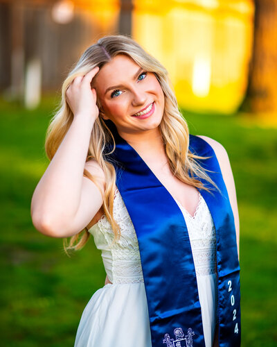 A Mount Rainer High School senior from Des Monies, Washington. She is smiling for her senior photos. The photoshoot location is at Browns Point Lighthouse in Tacoma, Washington.
