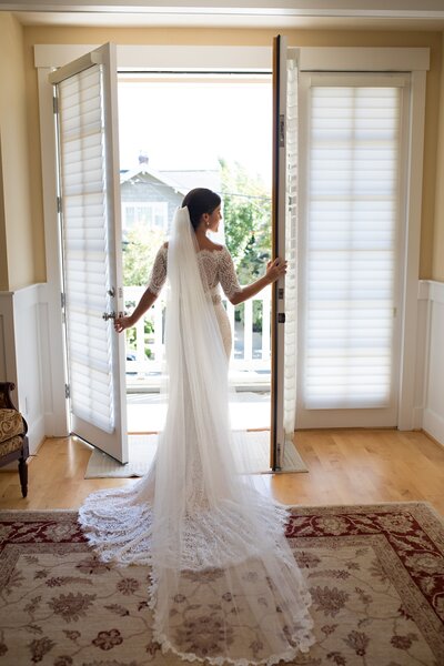 Bride looking out balcony window