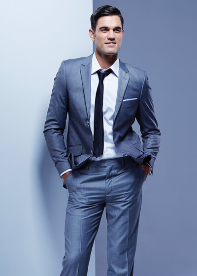 Handsome man blue suit studio shot.