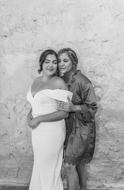 Bride sharing emotional moment with mother before ceremony