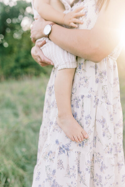 A close-up detail image of a mom holding her son during her family photography session in Grand Forks, ND.