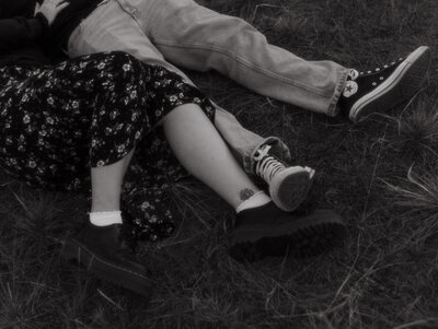 Nostalgic couples session in cranberry flats. Detail photo of couple laying on the grass.