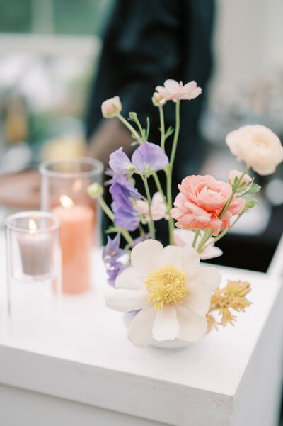 Floral-decorated table with champagne, mirror backdrop.