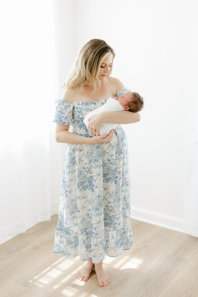 new mom photographed in a light filled studio by Charleston Newborn Photographer Tara Federico