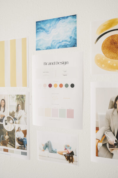 Brand design printouts from Krista Marie taped to a wall