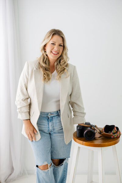 Photographer holding camera smiling in Harrisburg, PA