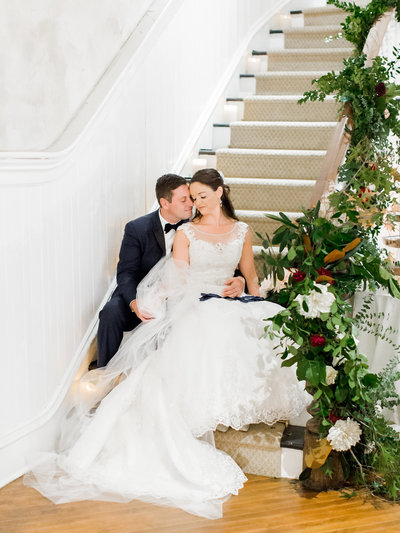 Bride and groom on floral lined stairs at The Excelsior