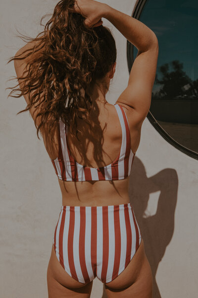 girl posing in red striped high waisted bikini