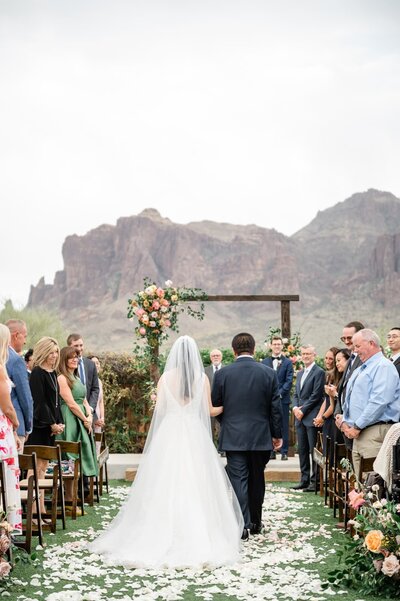 Bride walking down aisle  with father at The Paseo Wedding Venue
