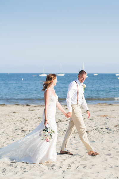 Bride and groom walk on the beach in Santa Barbara