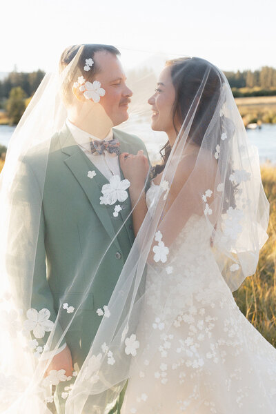 bride and groom holding hands while their bridal party is standing around them