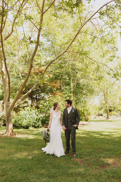 Bride and groom laughing during golden hour