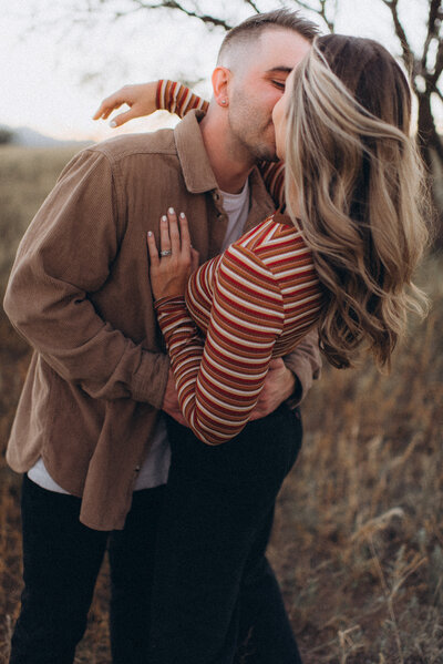 A couple being silly together in a Scottsdale field