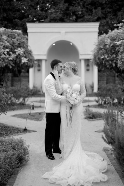 black and white shot of bride and groom walking out of church