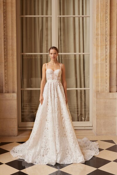 black and white image bride wearing strapless satin wedding dress with long train