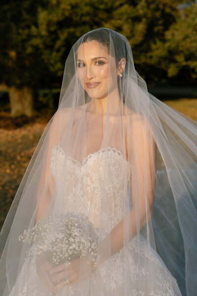 Couple in wedding attire holding hands and looking over San Francisco bay