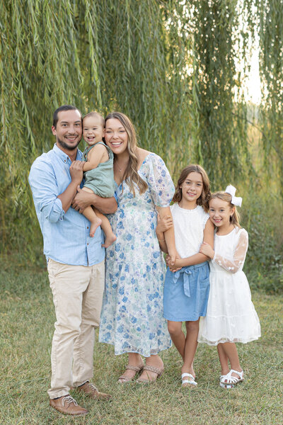 Family photo outside in a park