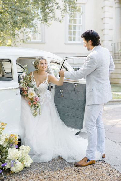 Husband and wife exit car at the Grand Marsh Estate