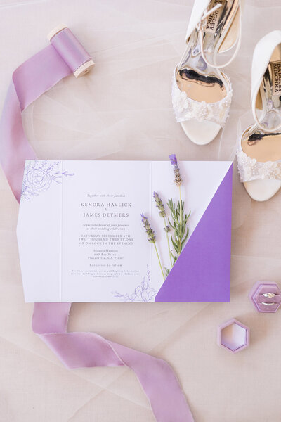 a lavender themed wedding invitation on a cream background