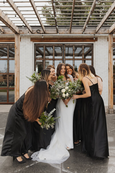 A bride and her bridesmaids hugging