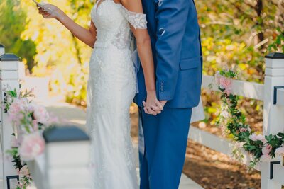 bride and groom holding hands at wedding venue in oklahoma