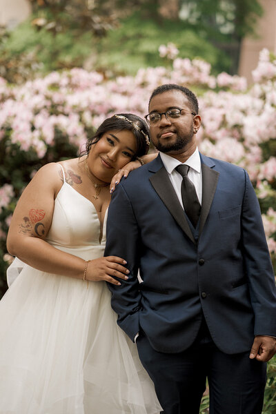 black couple on wedding day on the beach holding hands