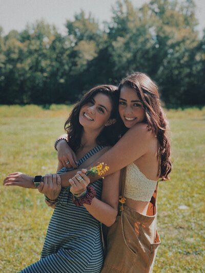 Two women look happy while hugging each other