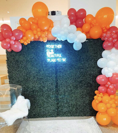 greenery backdrop and balloons