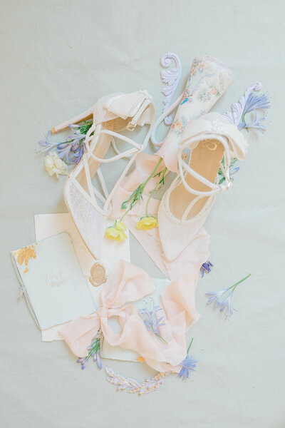 Elegant bridal details featuring lace heels, a delicate wedding invitation, and soft pink ribbons, captured at the DAR (Daughters of the American Revolution) in Washington DC. Felisha, a destination wedding photographer based in New England, specializes in capturing timeless and intimate moments at weddings in Washington DC, New England, and worldwide locations.