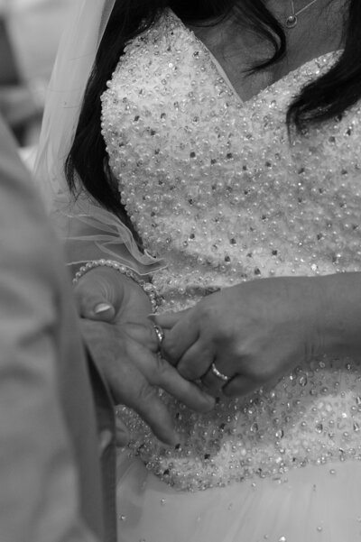 Bride putting wedding ring on groom’s finger during ceremony – Forever Package, Manchester wedding photography