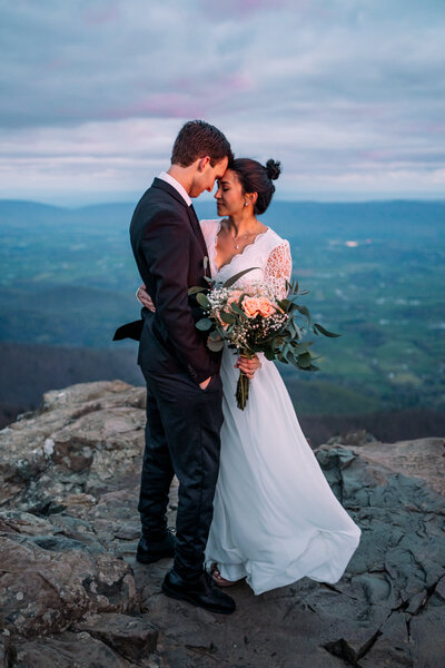 bride and groom hold each other on mountain in Shenandoah National Park elopement ceremony