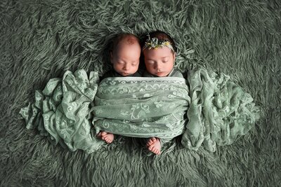Newborn twins, a boy and girl, posed together on a sage green fur during a mobile in-home session in Richmond.