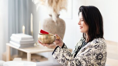 sound healer headshot with singing bowl