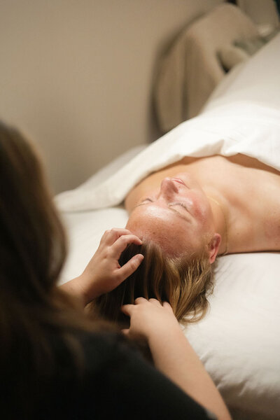 Close-up of scalp massage performed by licensed esthetician Macayla Hopper at her Hartselle skincare studio