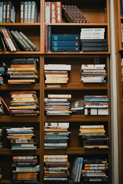 Close-up of a packed bookshelf from the Expat Book Club, highlighting global perspectives on parenting teens abroad.