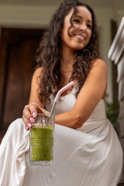 Branding photo of a woman with a green smoothie.