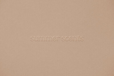 Custom embossed logo for a modern candle brand, incorporating minimalist icons and neutral shades.