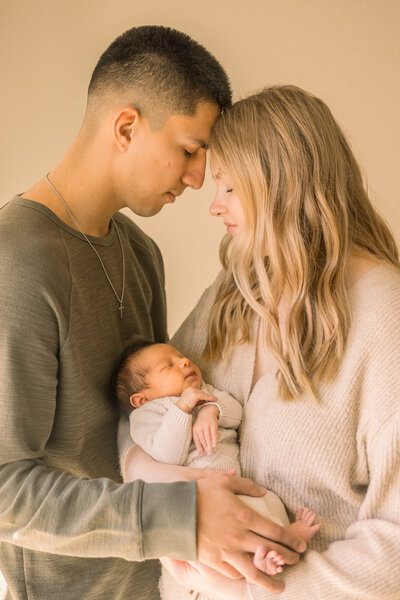 Mom and dad with newborn baby during family photos