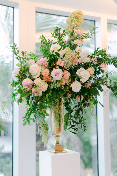 Fancy Floral Showpieces blooming with deep greens, white and pink roses.